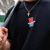 Person wearing a black t-shirt with 'BL101 Pablo Sanchez' logo and holding a baseball bat.