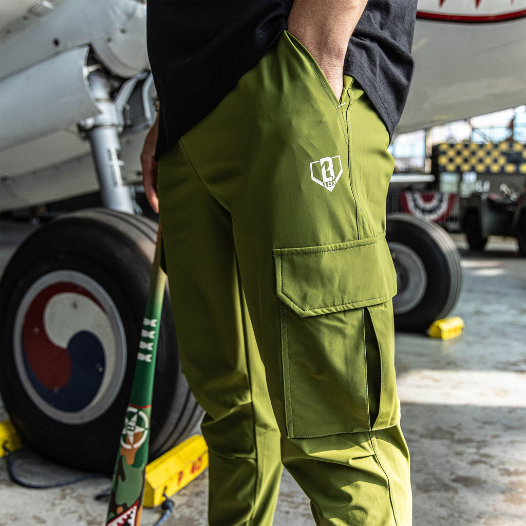 Olive green jogger cargo pants with drawstring waist, zippered pockets, utility cargo pockets, and white BL101 embroidered logo on side