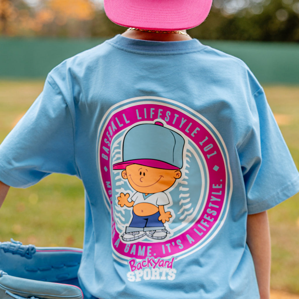 Person wearing a blue t-shirt with a Pablo Sanchez graphic design and text, standing outdoors.