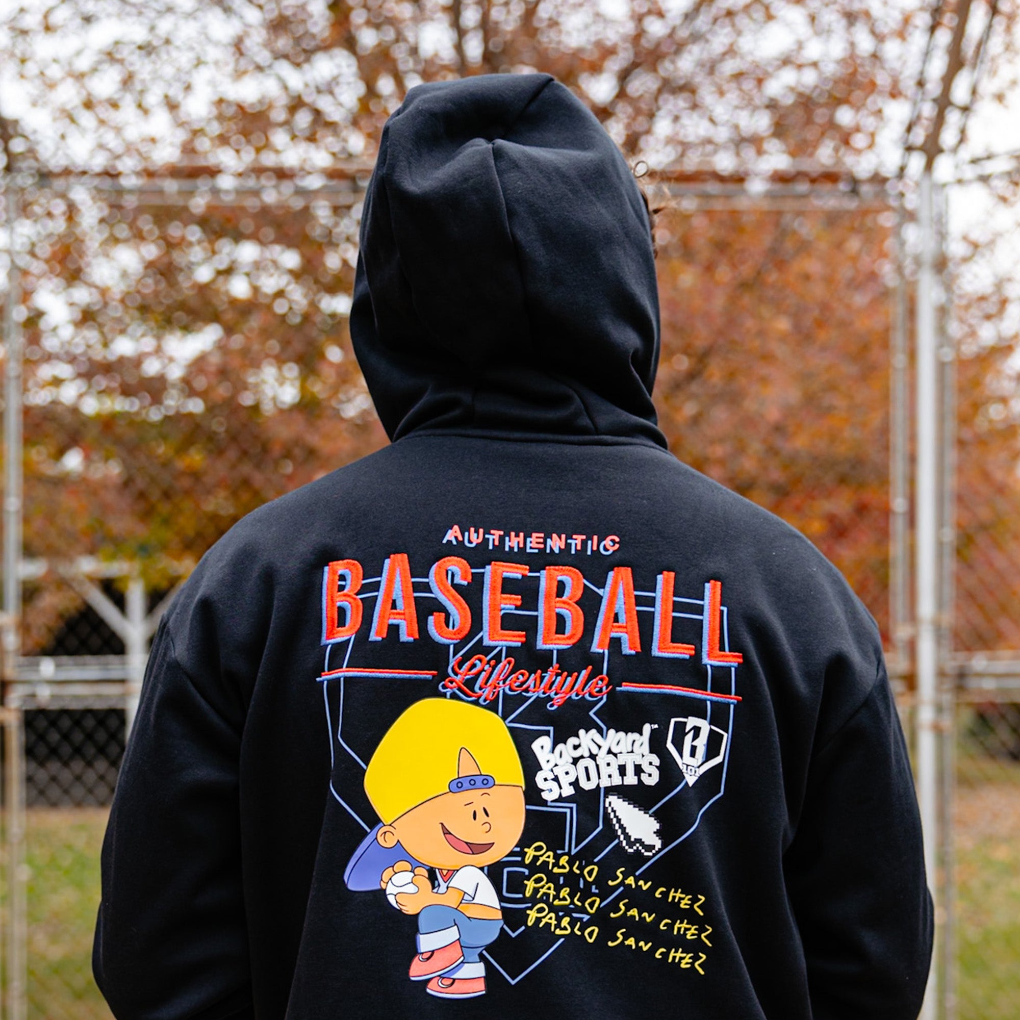 Person wearing Black hoodie with 'Authentic Baseball Lifestyle Pablo Sanchez' text