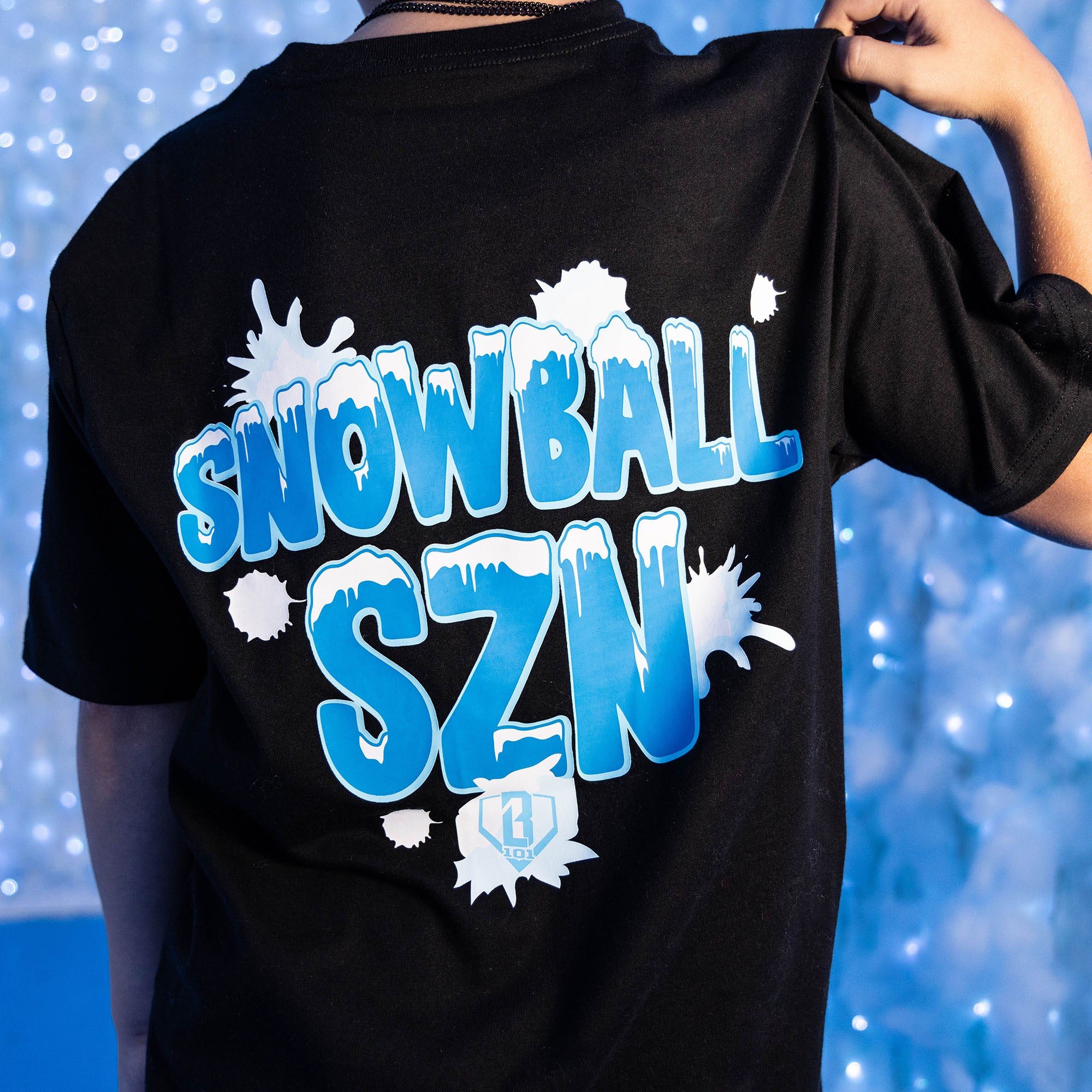 Adult model wearing graphic tee with “Snowball SZN” design