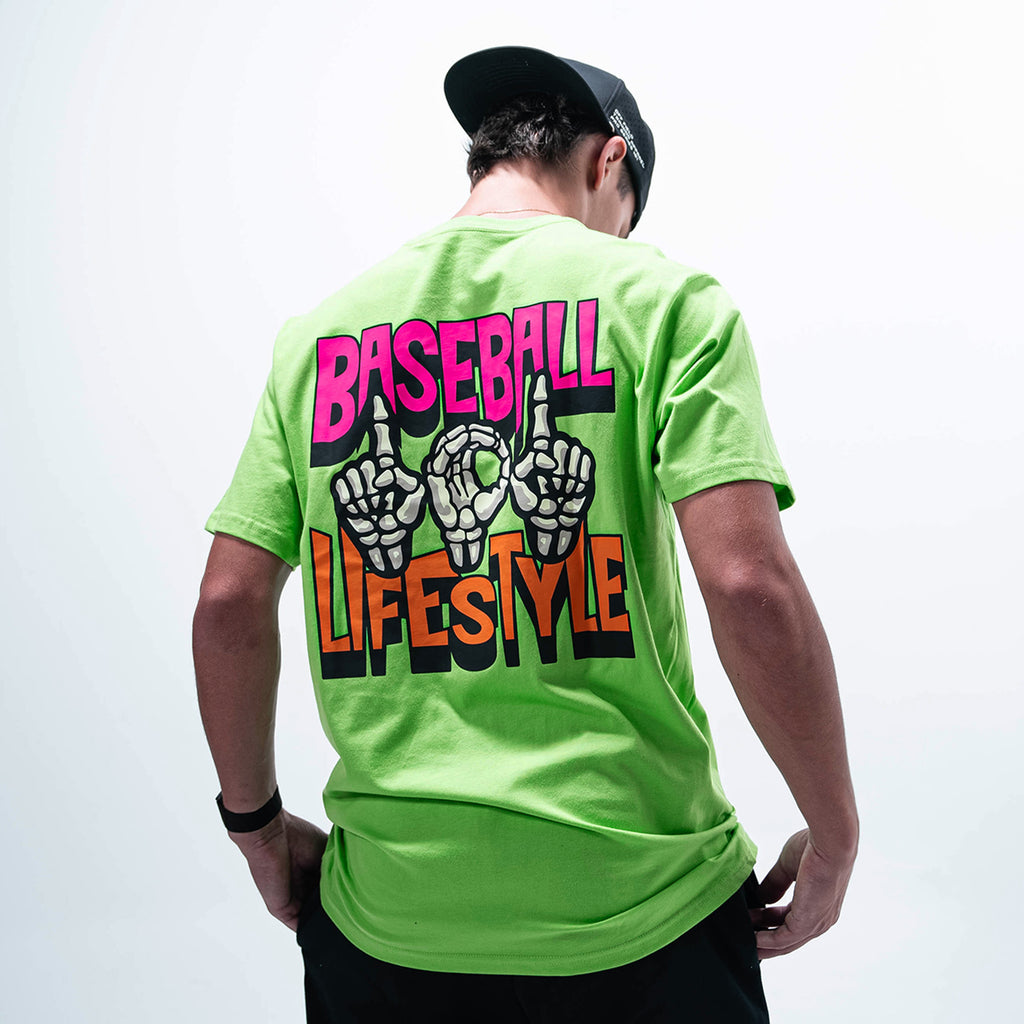 Adult model wearing green graphic tee with "101 Skeleton" design