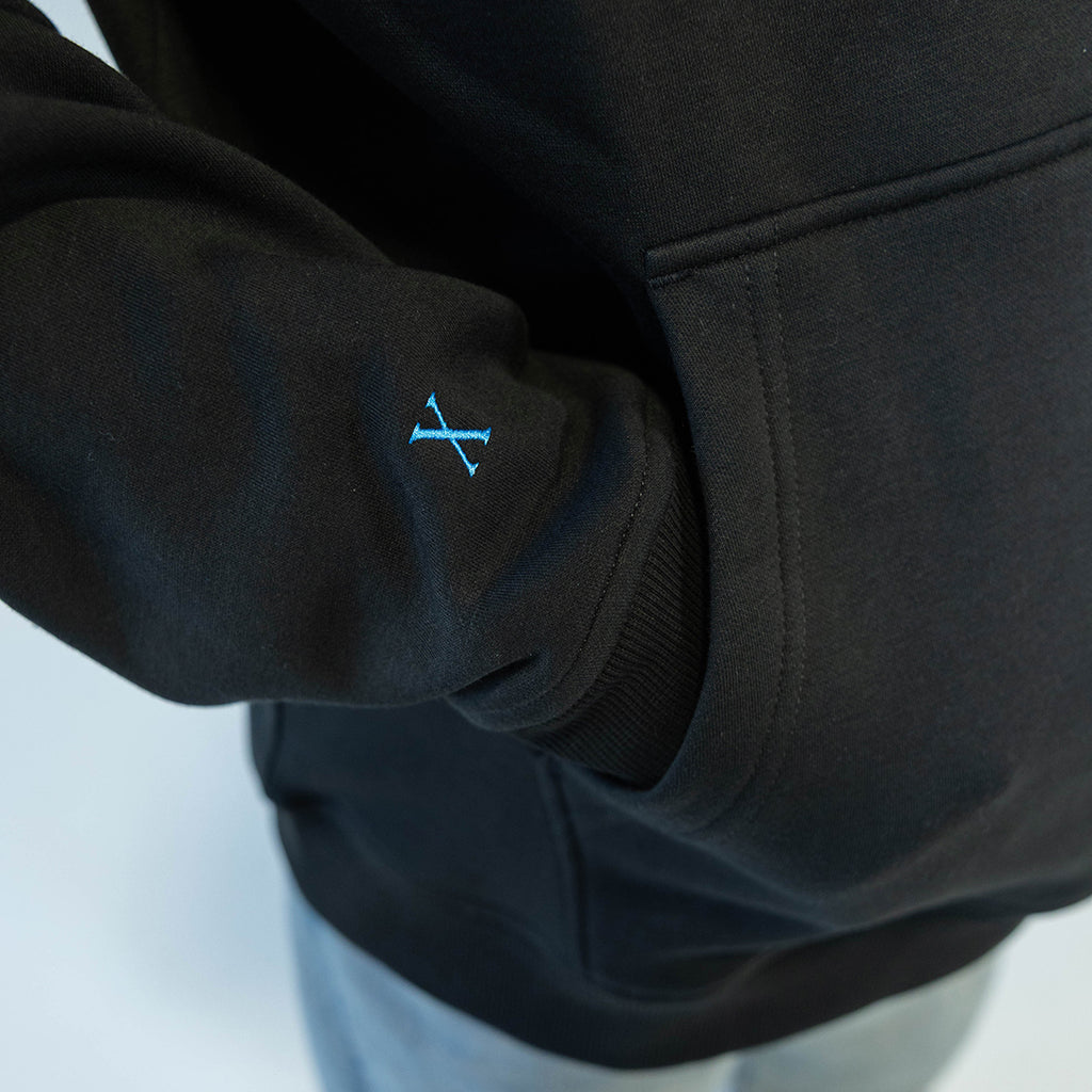 Adult model wearing black hoodie with "10 Year Anniversary" design