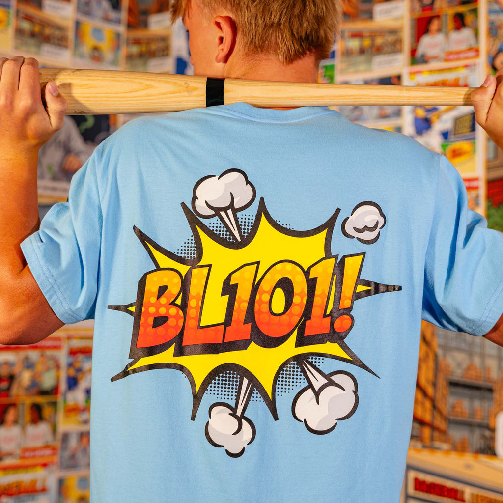 Adult model wearing blue graphic tee with "BL101 Comic" design