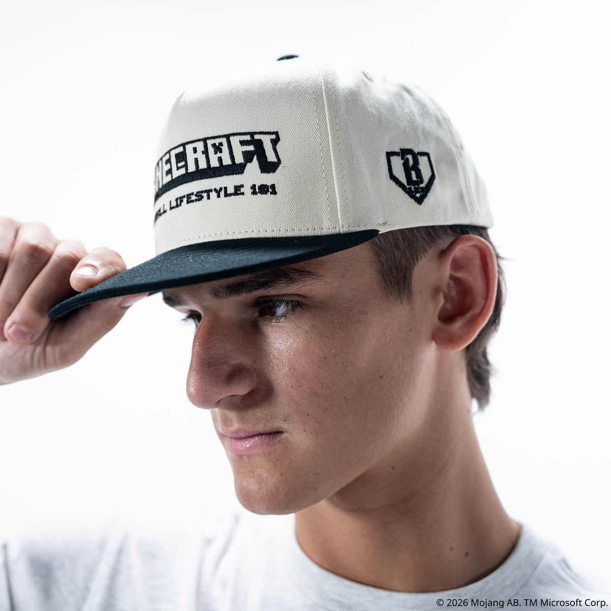 Adult model wearing black and white hat with "BL101 x Minecraft Sword" design