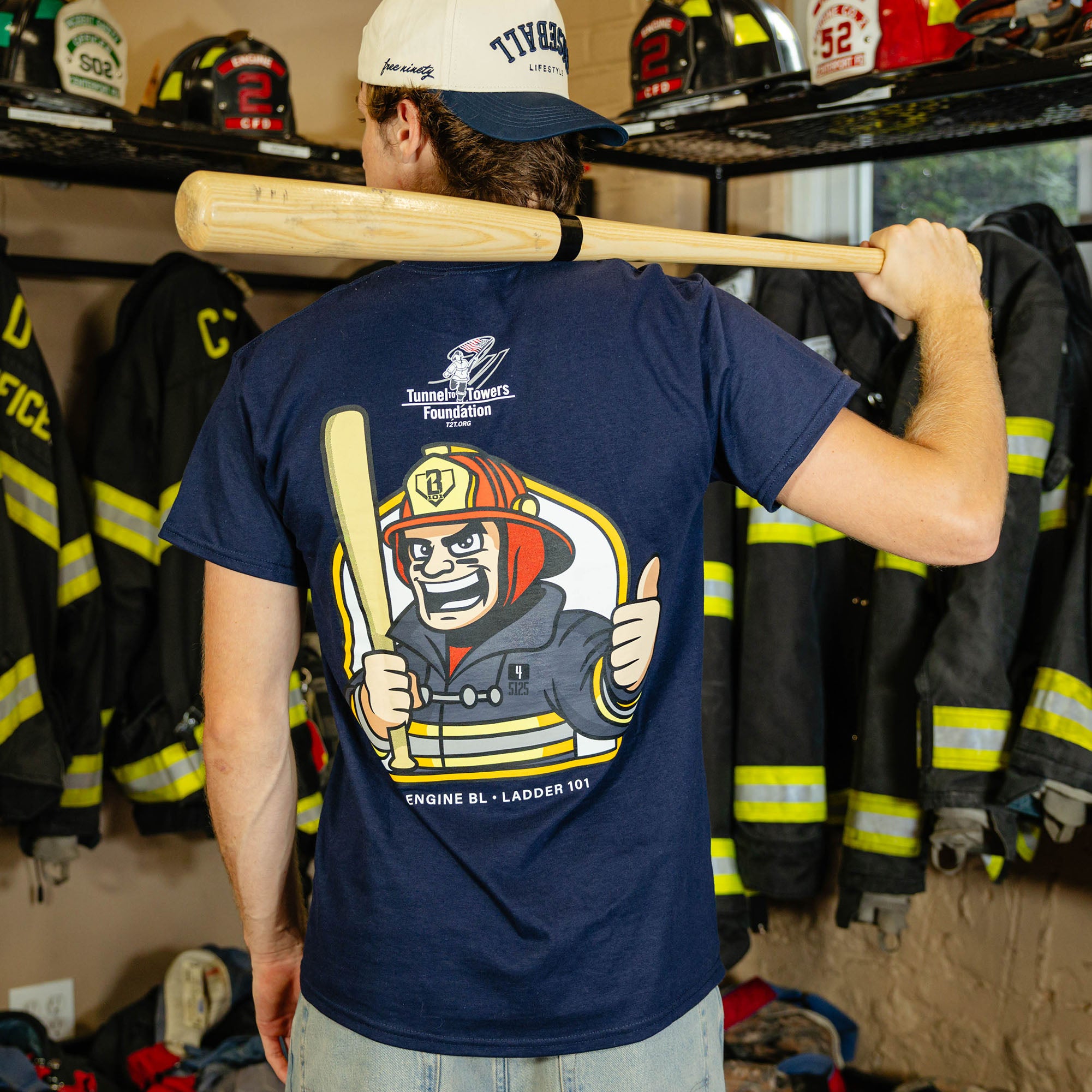 Adult model wearing Navy graphic tee with "BL101 X Tunnel to Towers Foundation" design