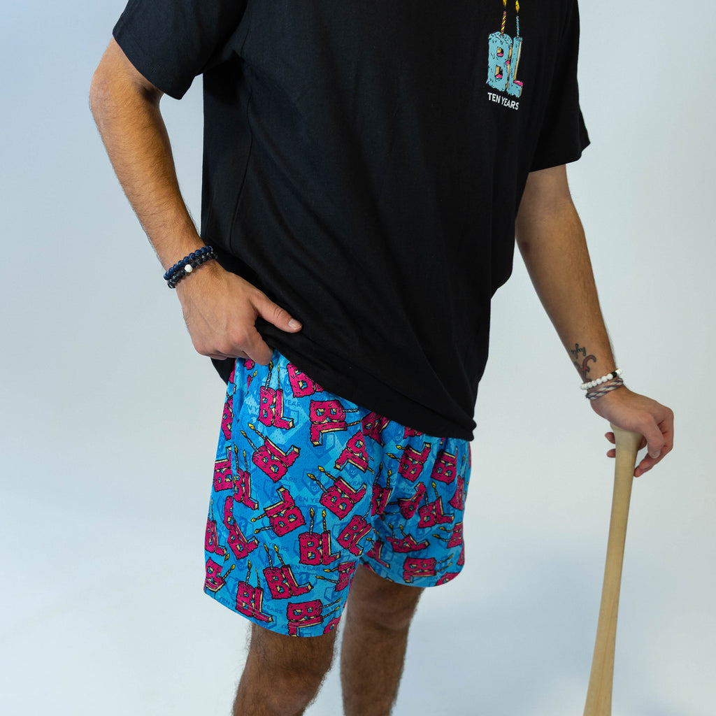Adult model wearing blue shorts with "BL Birthday" design
