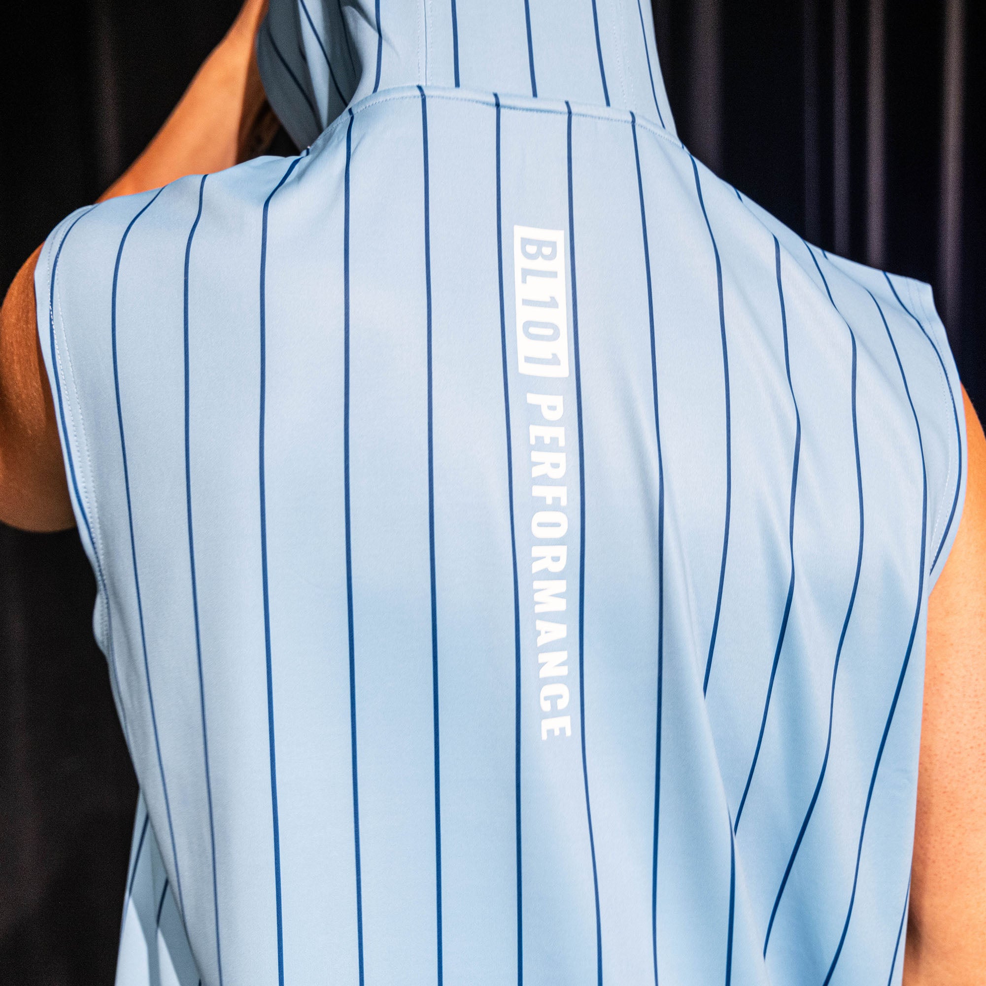 Back view of the light blue pinstripe BSBL-SZN Short Sleeve Hoodie V3 showing the vertical "BL101 Performance" graphic down the center