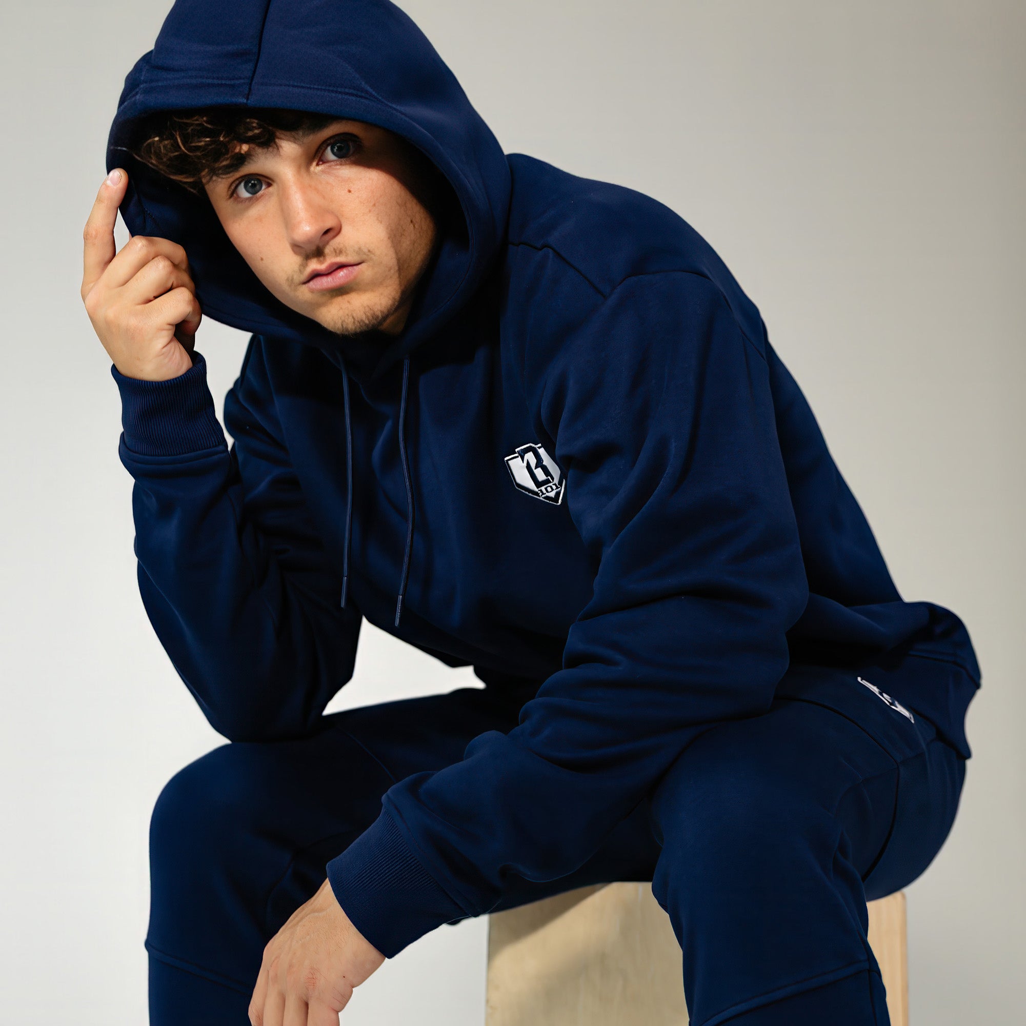 Adult model wearing Navy Baseline hoodie
