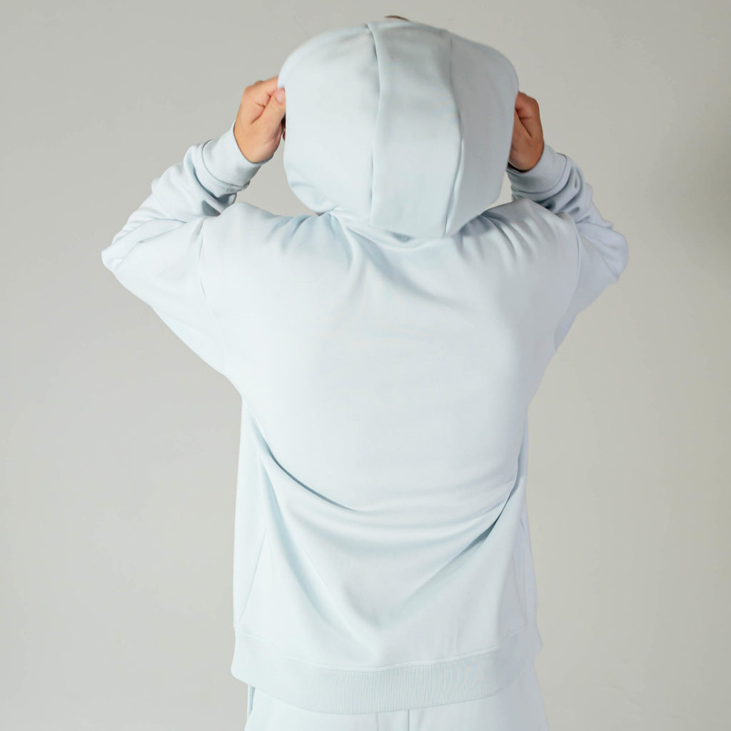 Adult model wearing Blue Baseline hoodie