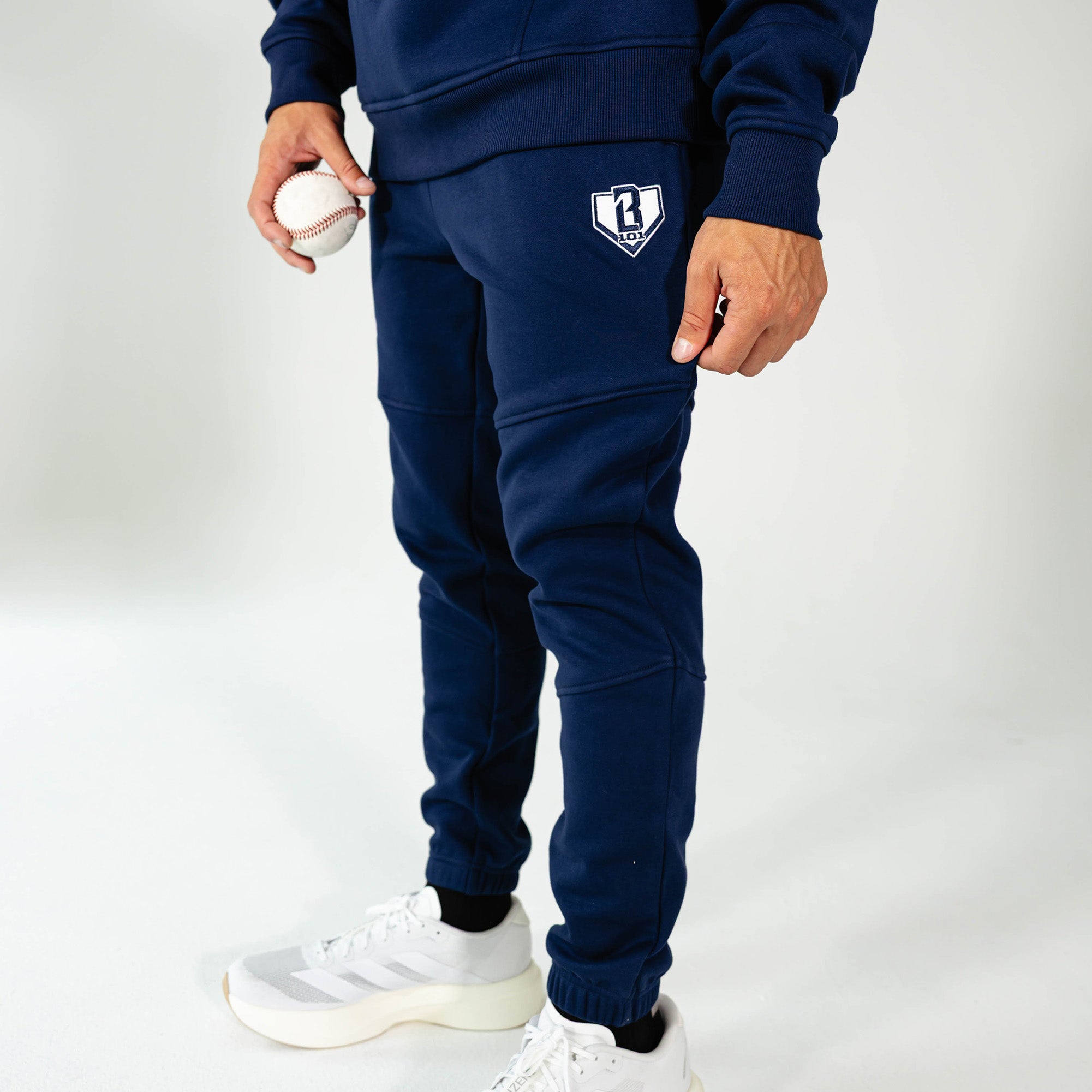 Adult model wearing Navy Baseline joggers