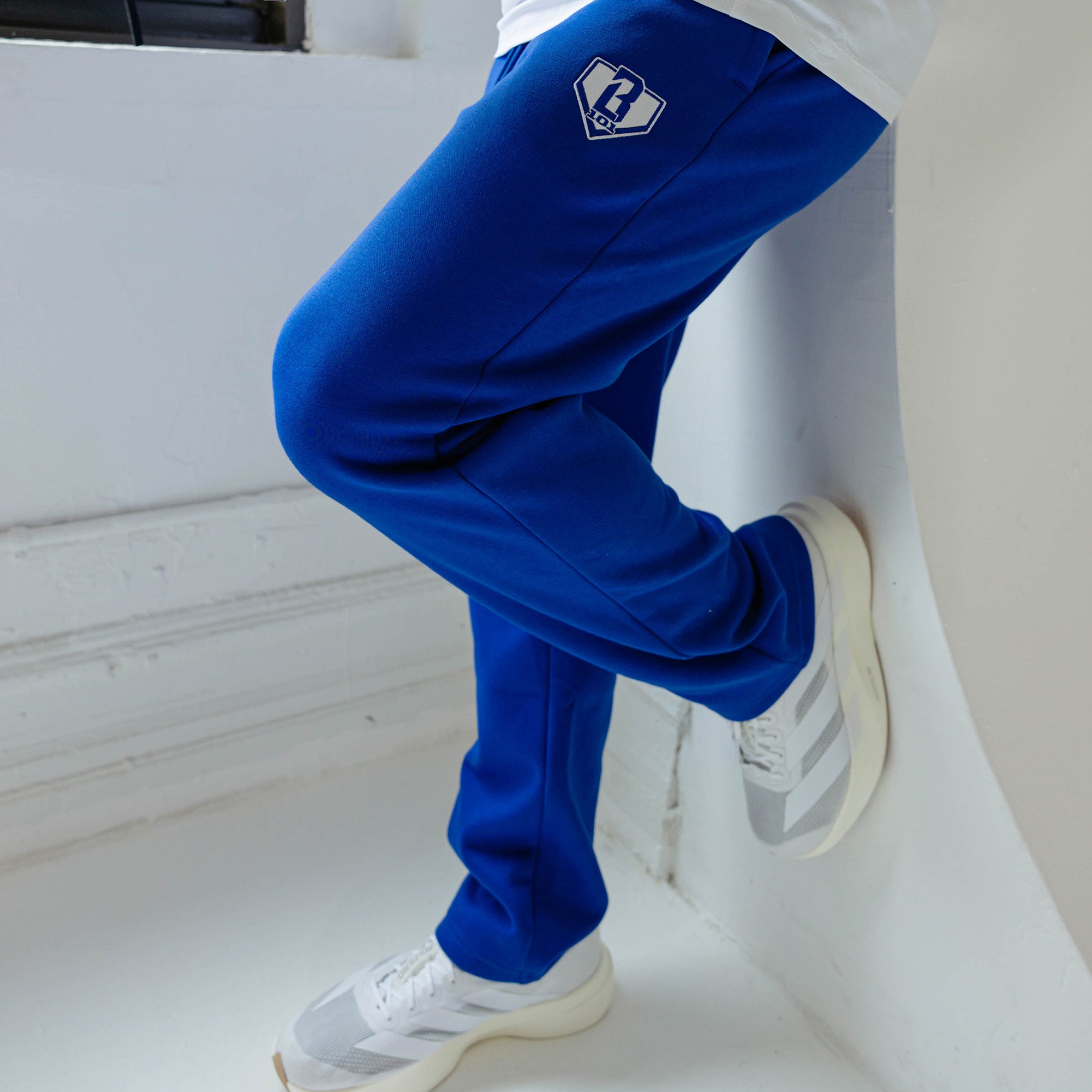 Adult model wearing Blue Baseline Straight Leg sweatpants