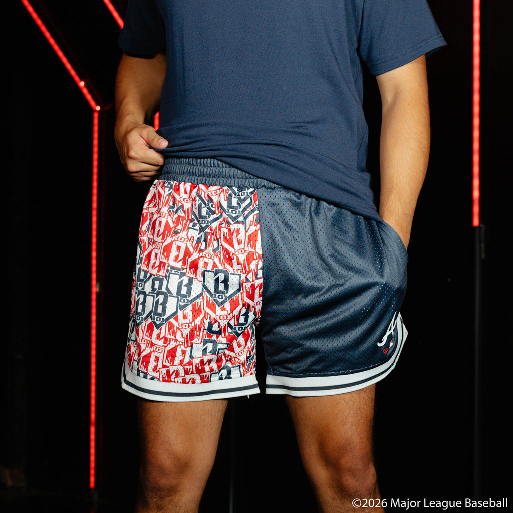 Adult model wearing navy shorts with "Atlanta Braves Sticker Court" design