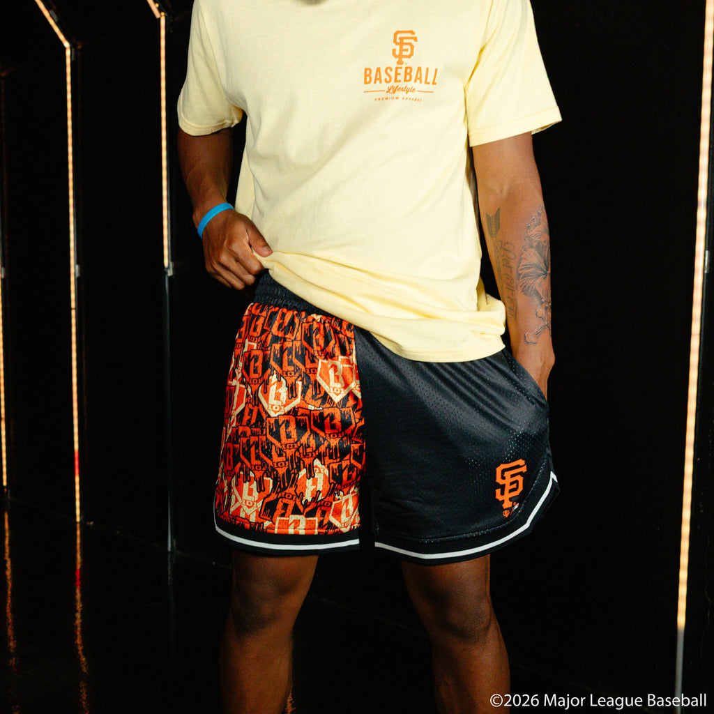 Adult model wearing black shorts with "San Francisco Giants Sticker Court" design