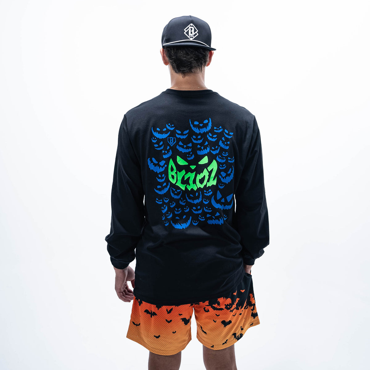 Adult model wearing black long sleeve tee with "Jack O' Lantern Team" design