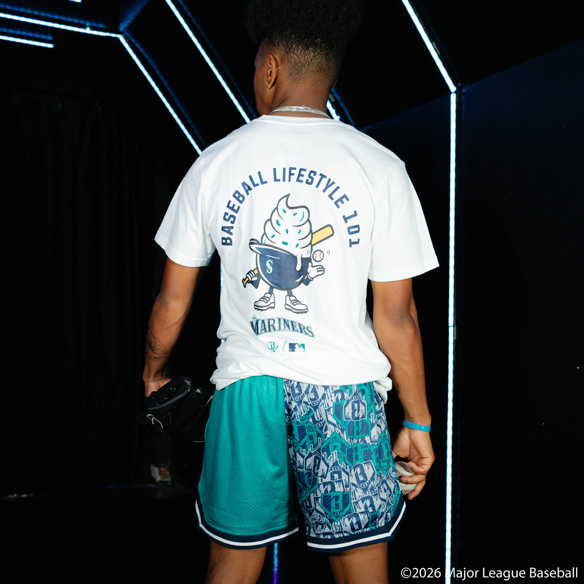 Adult model wearing white graphic tee with "Seattle Mariners Ice Cream Cap" design