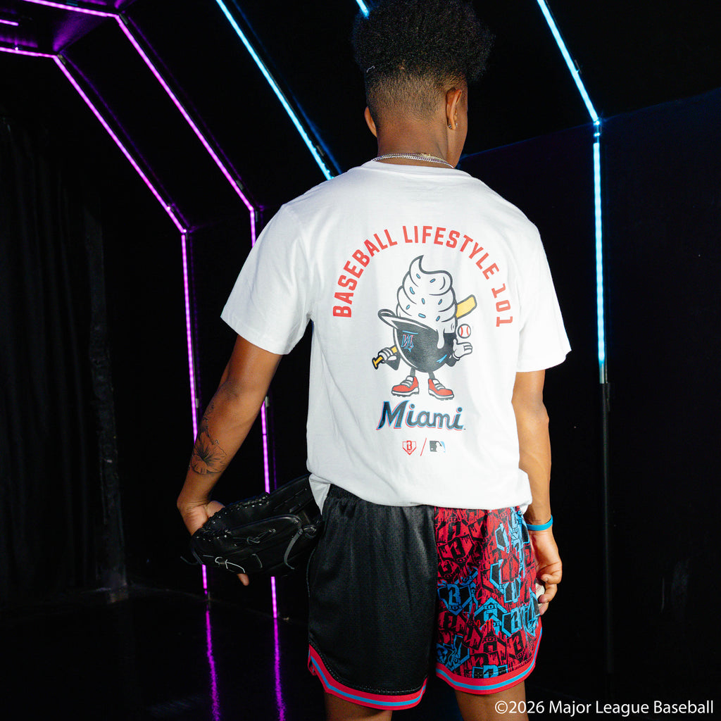 Adult model wearing white graphic tee with "Miami Marlins Ice Cream Cap" design