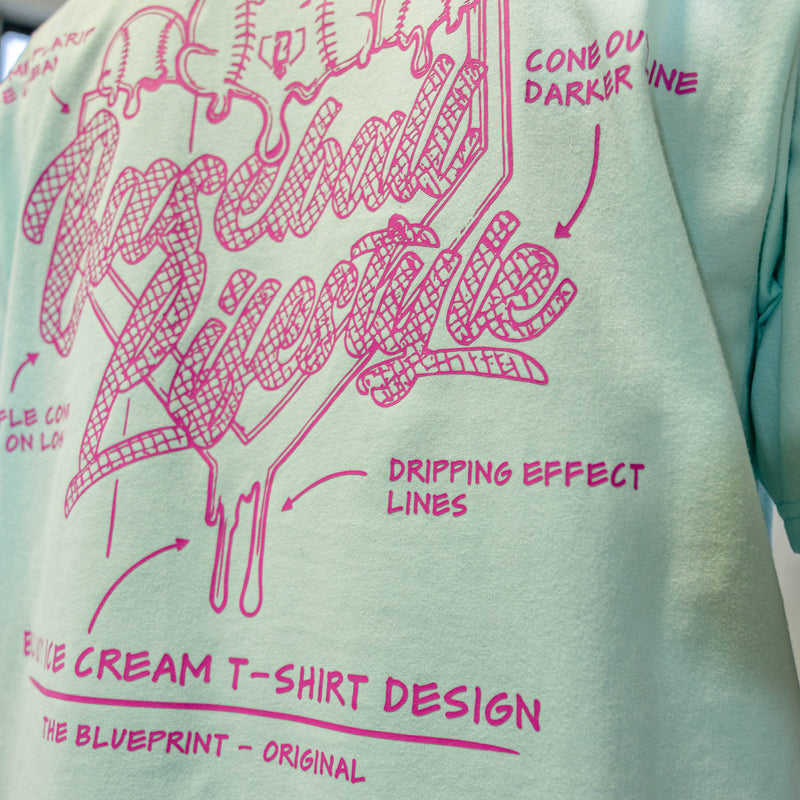 Light green t-shirt with pink ice cream cone design and Baseball Lifestyle text on a white background