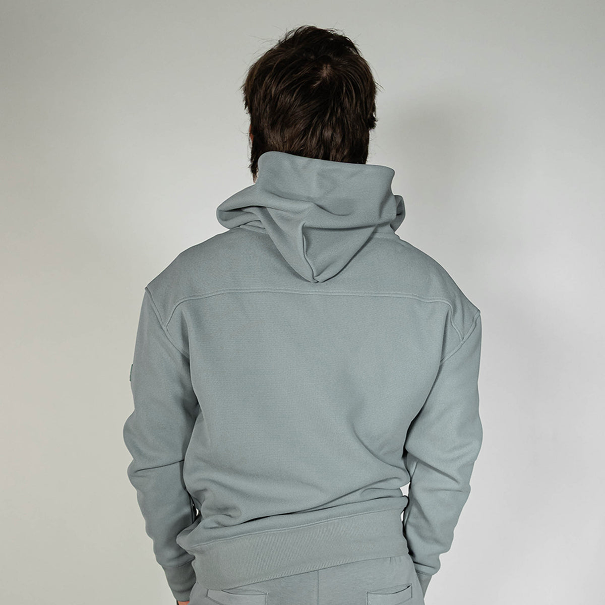 Adult model wearing gray Realtree Aspect Off-Field Waffle Performance Camo hoodie