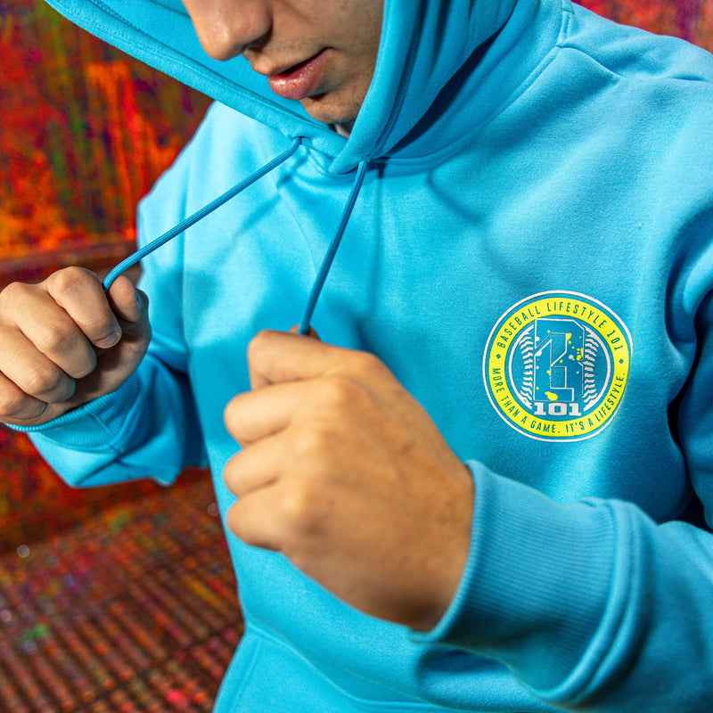 Person wearing a blue hoodie with a BL101 logo on the chest against a colorful background