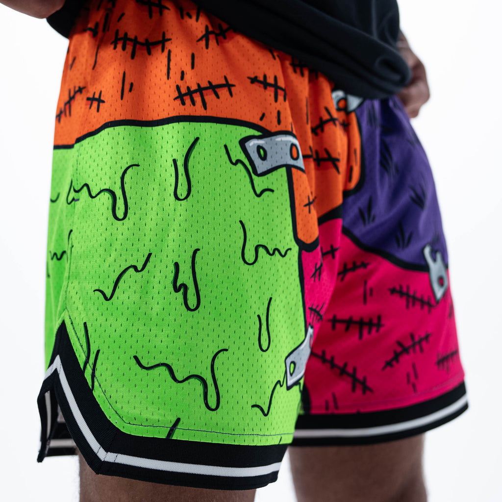 Adult model wearing multi-color shorts with "Stitched For The Show" design