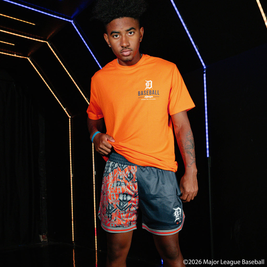 Adult model wearing navy shorts with "Detroit Tigers Sticker Court" design