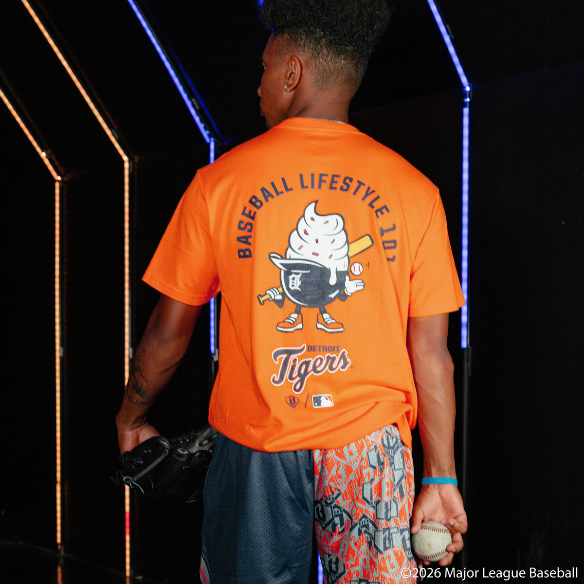 Adult model wearing orange graphic tee with "Detroit Tigers Ice Cream Cap" design