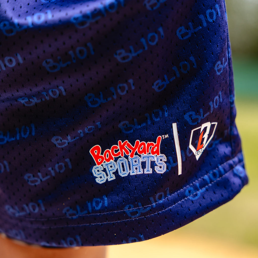 Close-up of a blue shorts with 'Backyard Sports BL101' logo on a blurred background