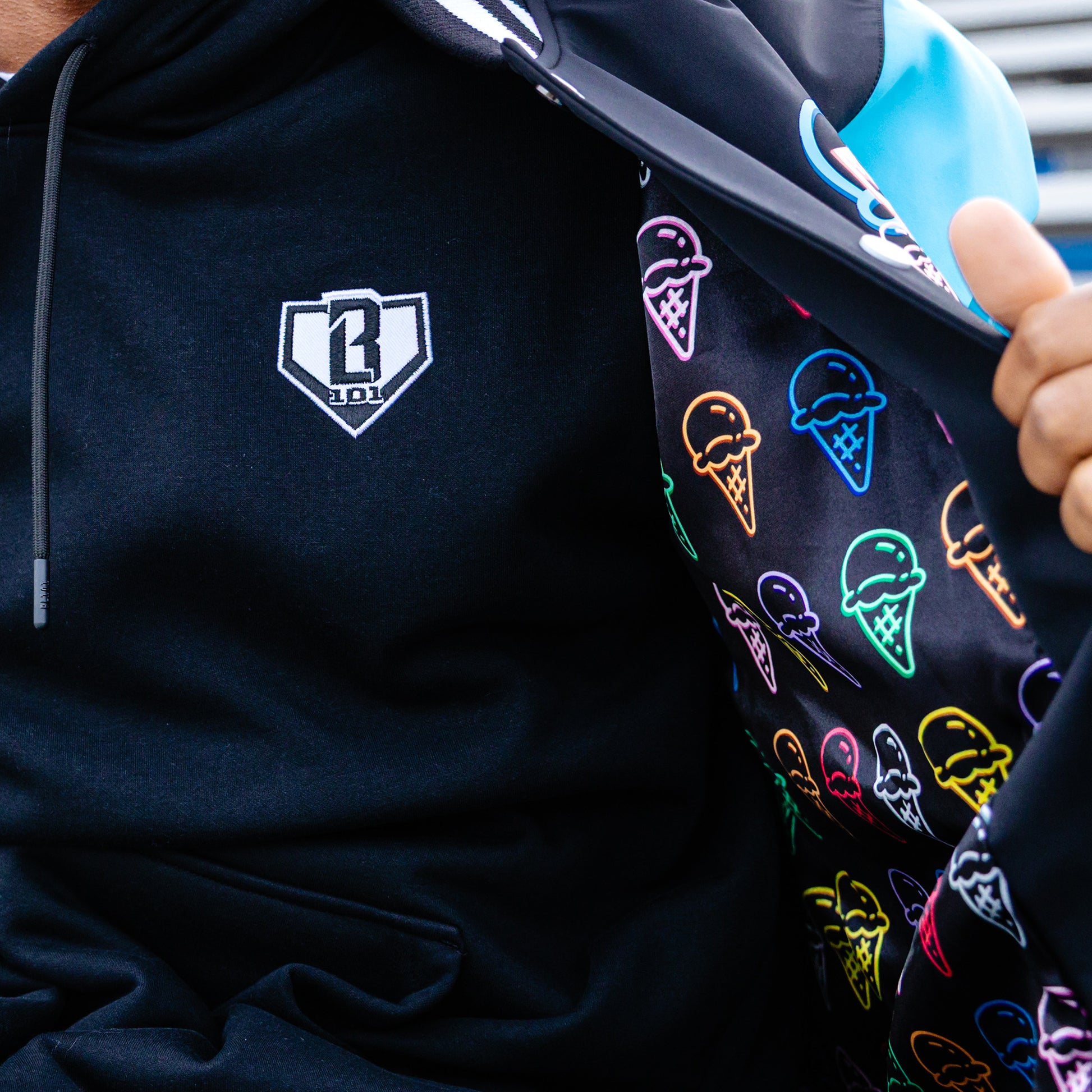 Black hoodie with a BL101 logo on the chest and jacket with colorful ice cream cone patterns on the inside.