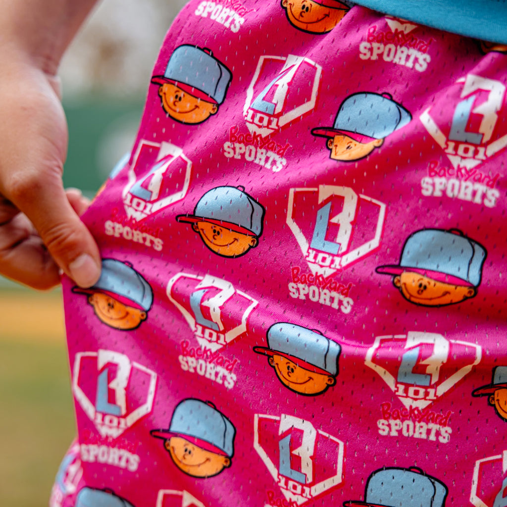 Pink fabric with Pablo Sanchez and 'BL101 Backyard Sports' logos, held by a hand.