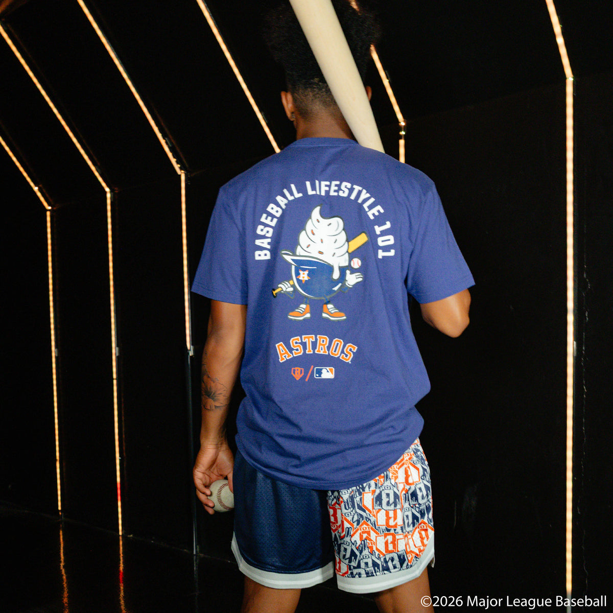 Adult model wearing blue shorts with "Houston Astros Sticker Court" design