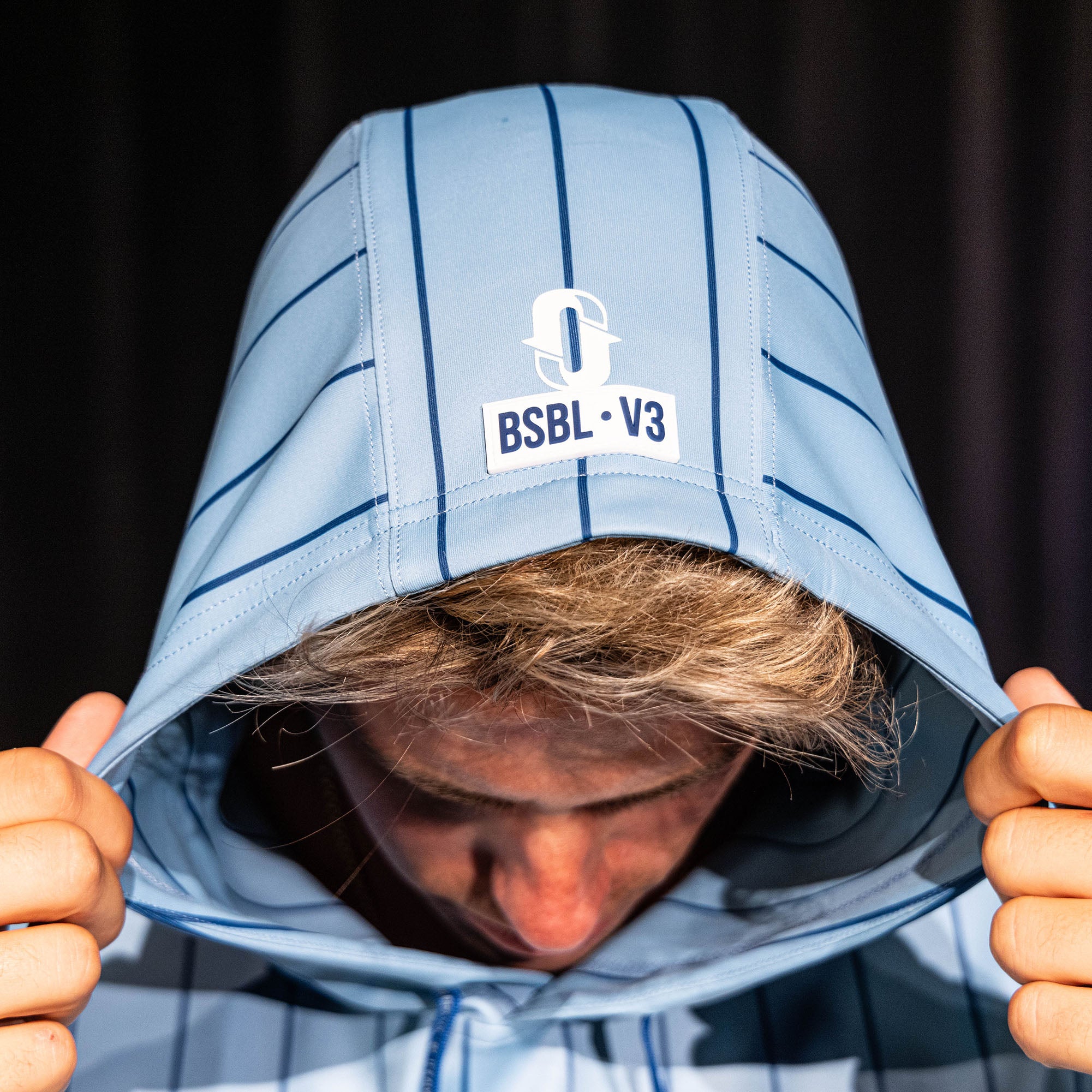 Person wearing a blue and white striped hoodie with 'BSBL V3' logo.