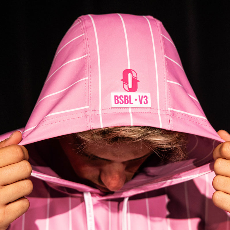 Close-up of the hood on the pink pinstripe BSBL-SZN Short Sleeve Hoodie V3 showing the Jackson Olson "O" logo and "BSBL·V3" label