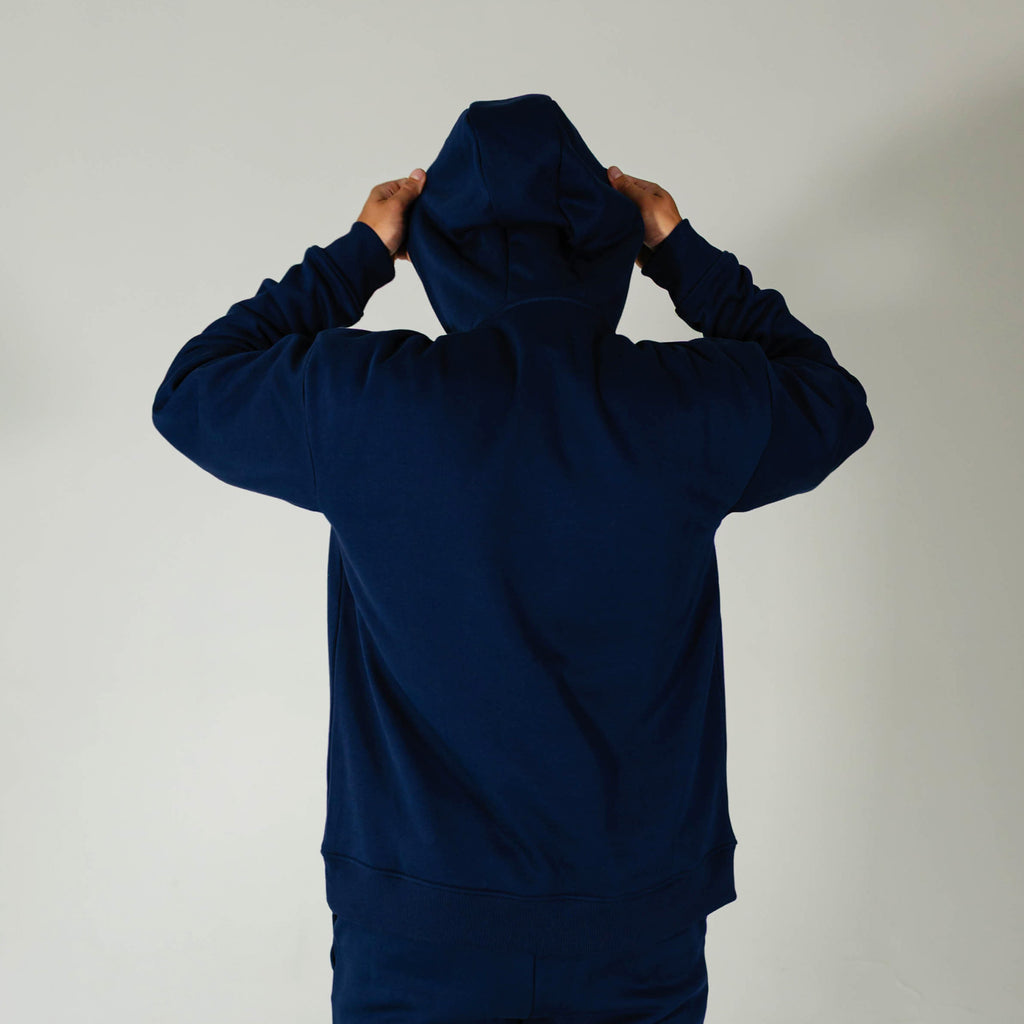Adult model wearing Navy Baseline hoodie
