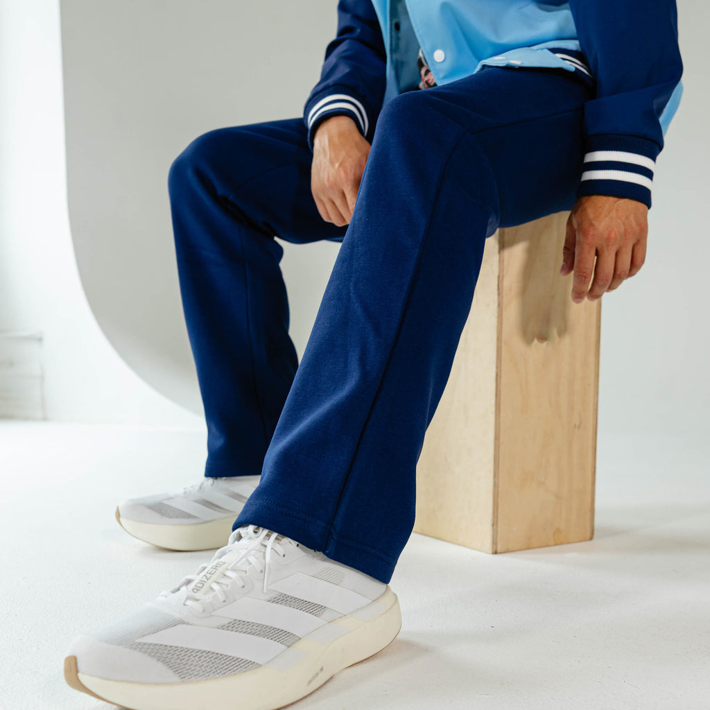 Adult model wearing Navy Baseline Straight Leg sweatpants