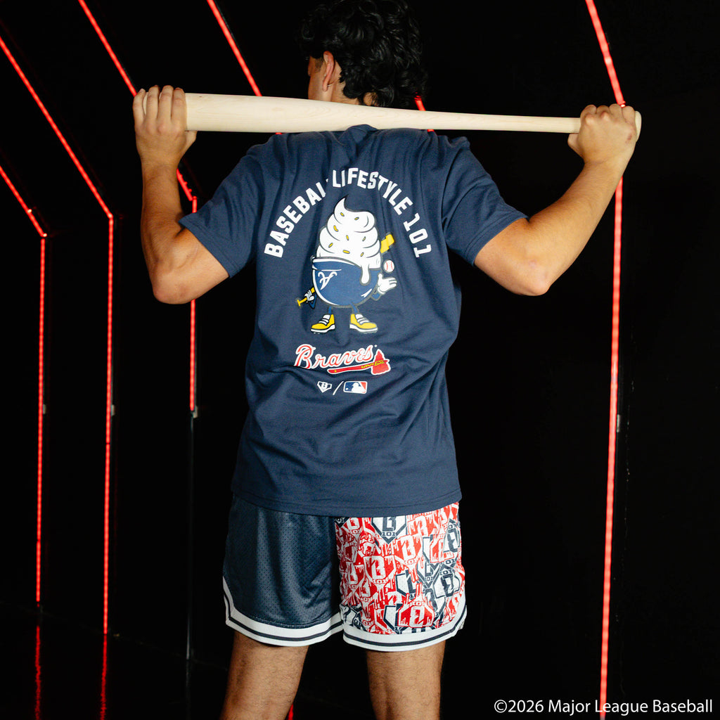 Adult model wearing navy shorts with "Atlanta Braves Sticker Court" design