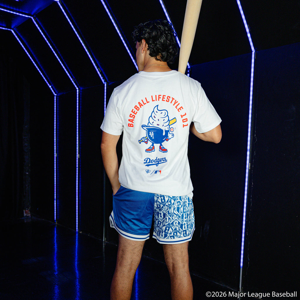 Adult model wearing blue shorts with "Los Angeles Dodgers Sticker Court" design