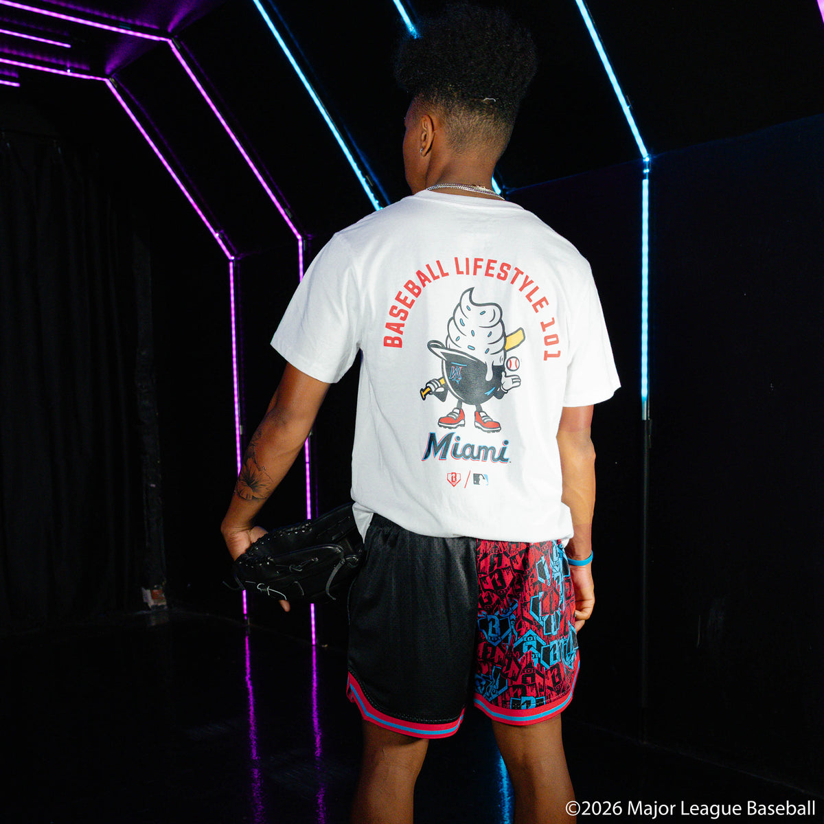 Adult model wearing black shorts with "Miami Marlins Sticker Court" design