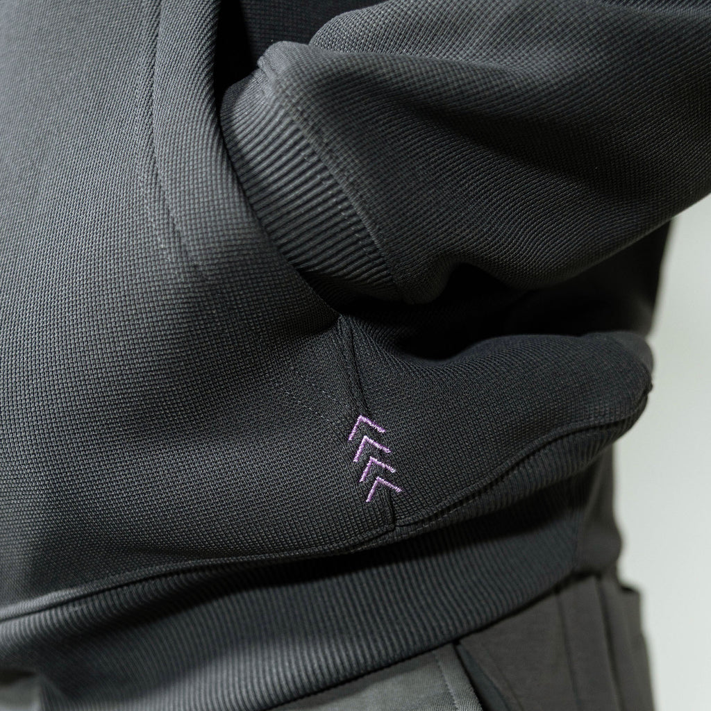 Adult model wearing gray and lilac Off-Field Waffle Performance hoodie