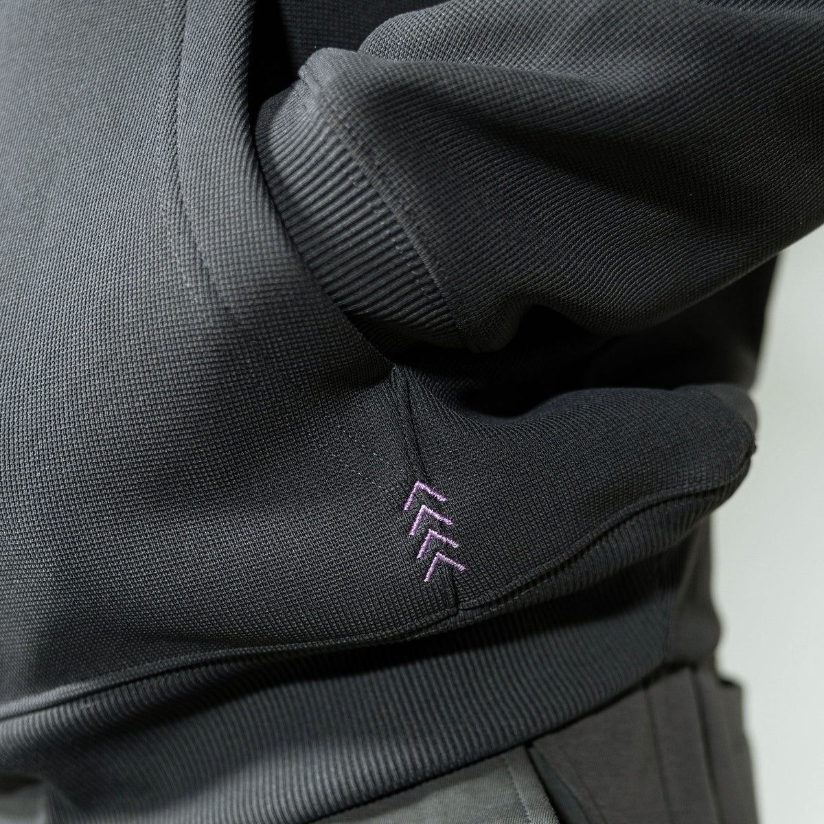 Adult model wearing gray and lilac Off-Field Waffle Performance hoodie
