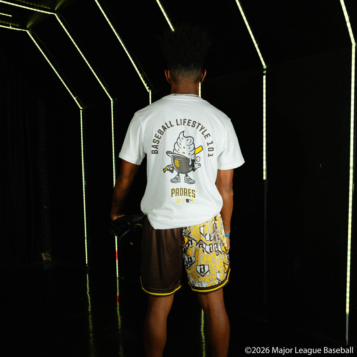 Adult model wearing shorts with "San Diego Padres Sticker Court" design