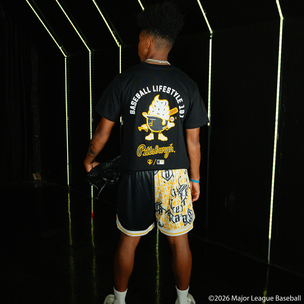 Adult model wearing black shorts with "Pittsburgh Pirates Sticker Court" design