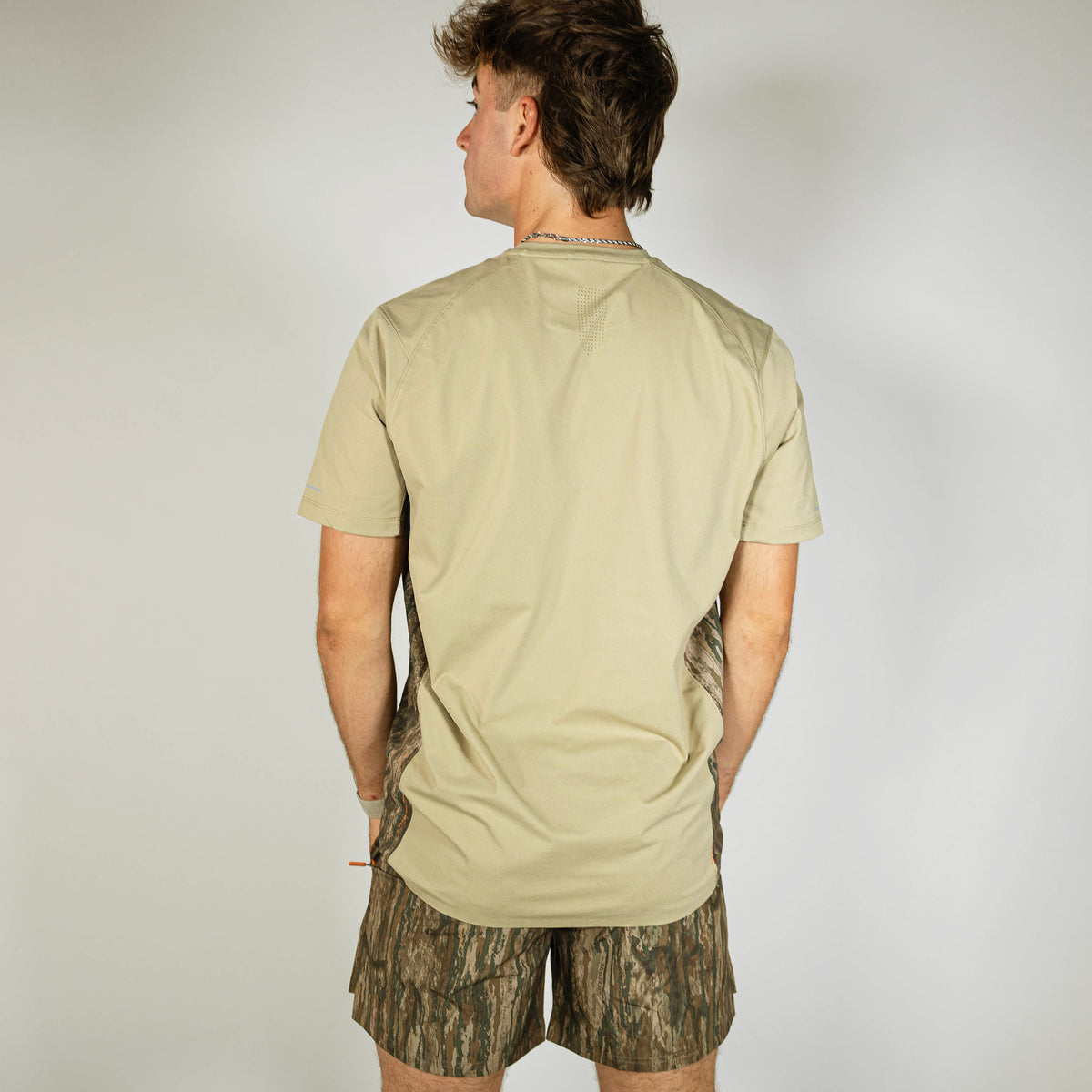 Adult model wearing multi-color Realtree Legacy Pro Series V2 Camo shorts with liner
