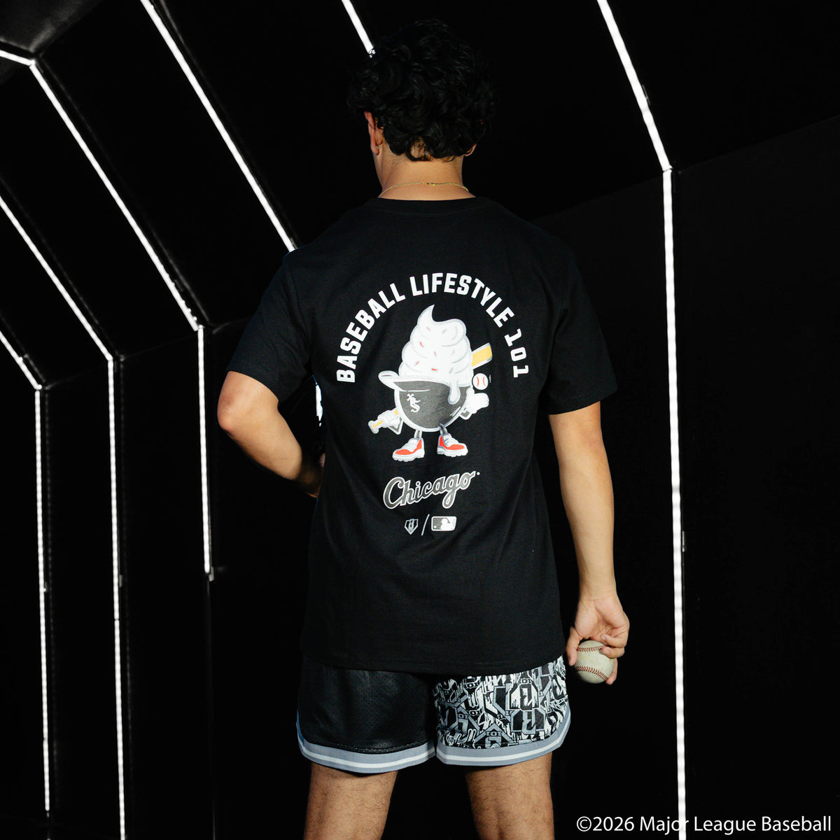 Adult model wearing black shorts with "Chicago White Sox Sticker Court" design