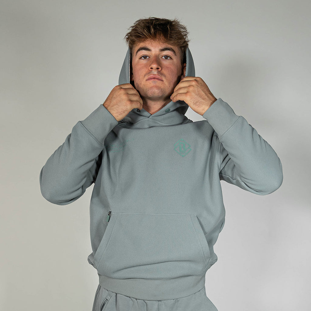 Adult model wearing gray Realtree Aspect Off-Field Waffle Performance Camo hoodie