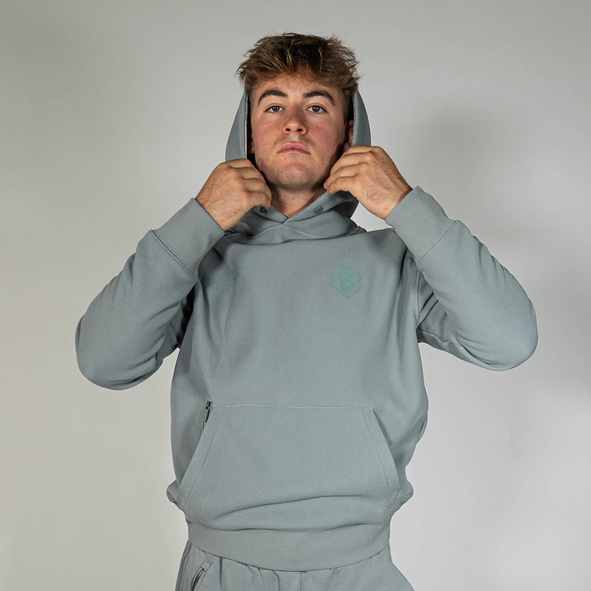 Adult model wearing gray Realtree Aspect Off-Field Waffle Performance Camo hoodie