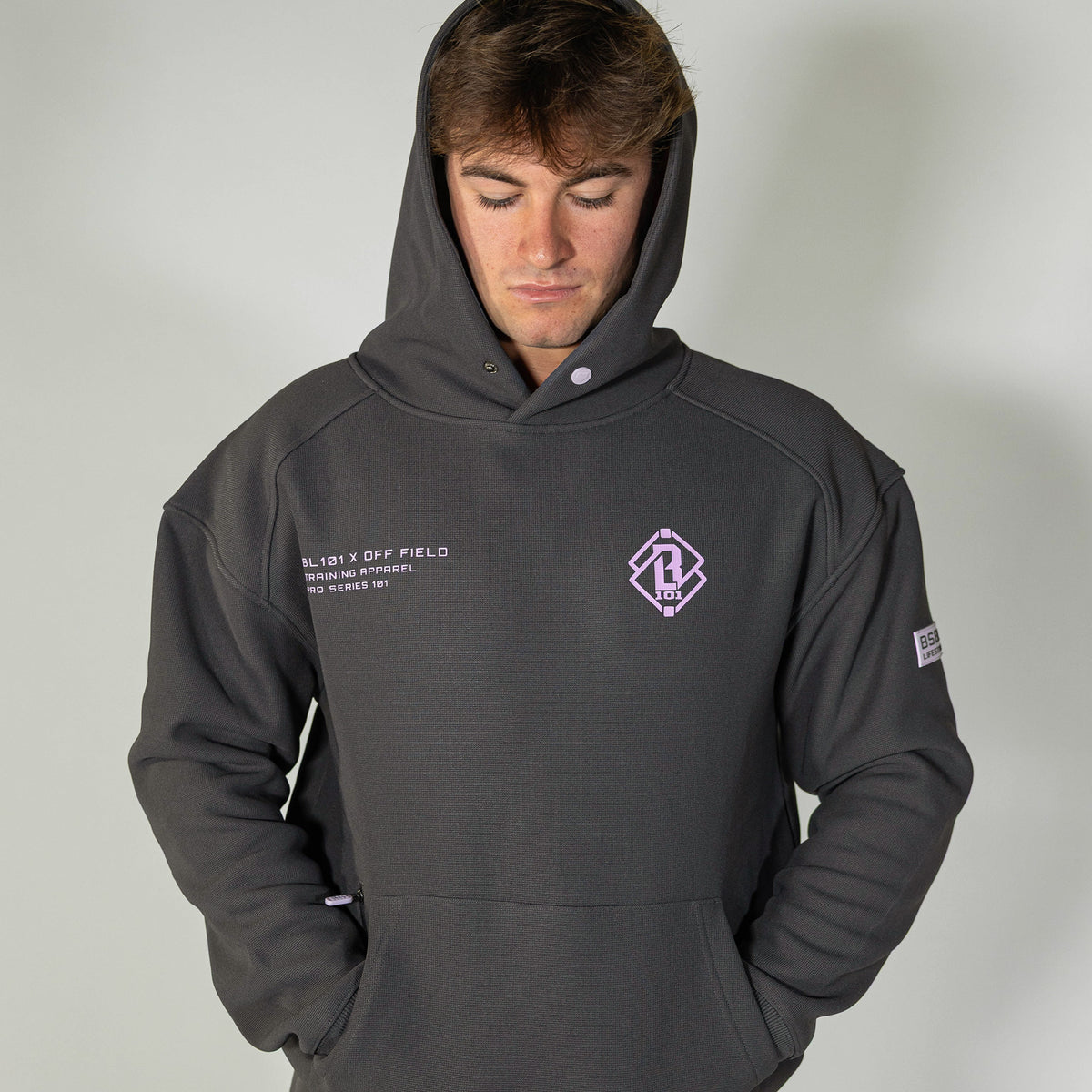 Adult model wearing gray and lilac Off-Field Waffle Performance hoodie