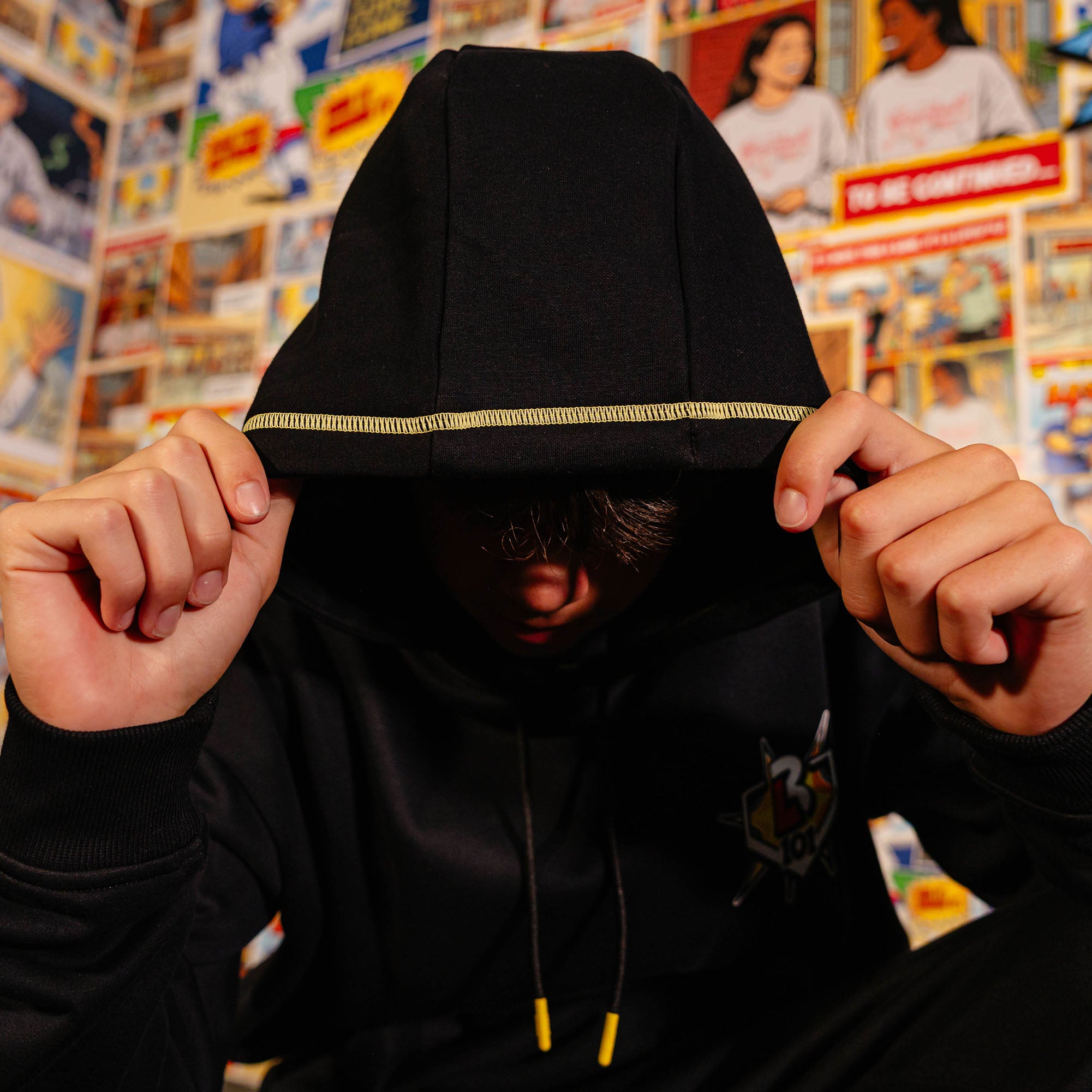 Adult model wearing black hoodie with "Power Hitter" design