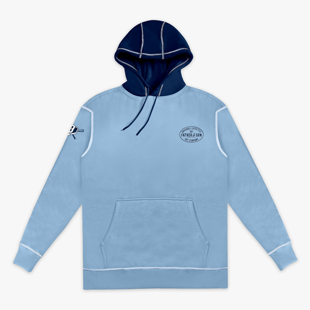 Flat lay front view of the adult columbia blue BL101 Bat Co Hoodie showing the Father & Son Bat Company chest stamp, BL101 sleeve logo, navy contrast hood, and kangaroo pocket.