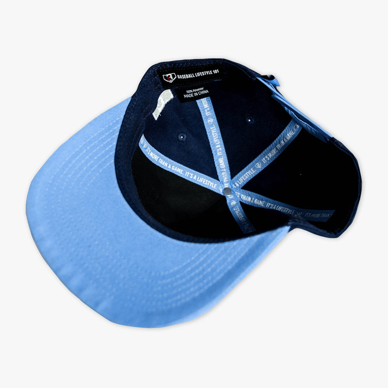 Interior view of the BL101 Bat Co Snapback showing the columbia blue brim underside, BL101 brand label, and signature "It's More Than a Game. It's a Lifestyle." interior taping.